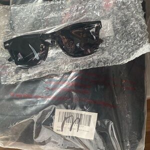 Men in black unisex costume. Pockets on blazer & pants. Free glasses w/purchase